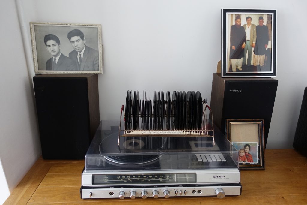 Sideboard showing 1970s stereo and family photos